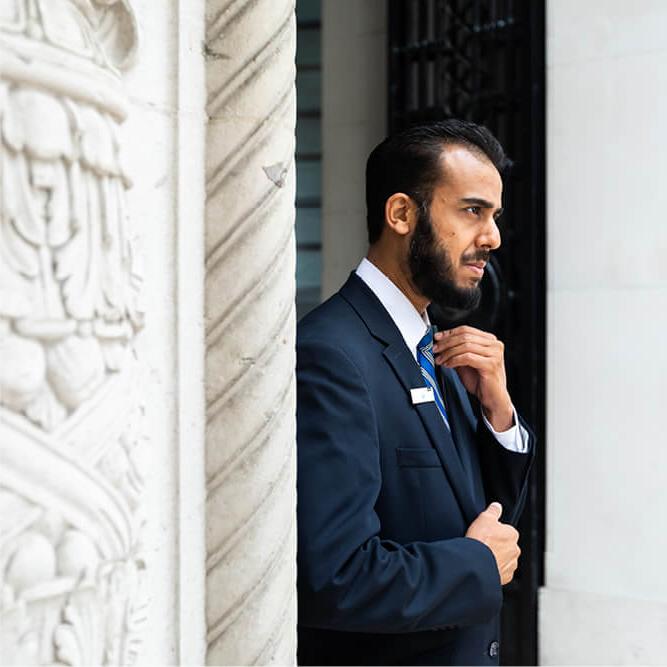 Male security guard standing in a doorway